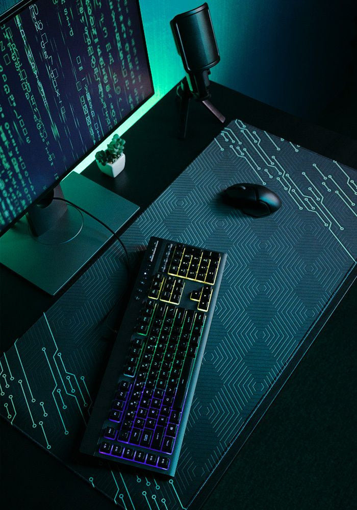 Desk mat with blue circuit board design, keyboard and mouse on top