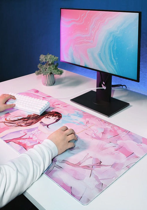 Desk mat with pink anime illustration, white keyboard on top